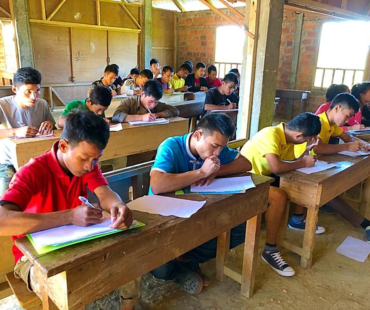 Students writing tests for the SOLWW scholarship